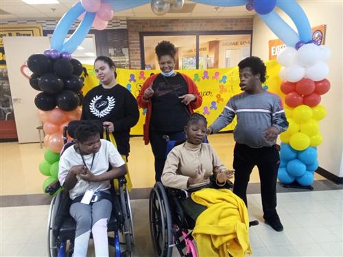 Students posing in front of ballon arch 